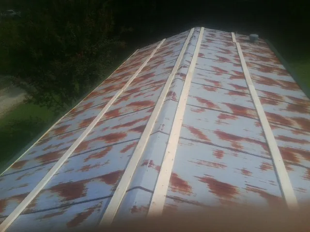 Rusted metal roof panels with new wood purlins before replacement — Storm Damage Roof Repair in North Myrtle Beach by Roofing Brothers